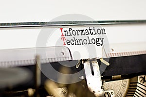 IT information technology symbol. Concept words IT information technology on white paper typed on retro typewriter. Beautiful