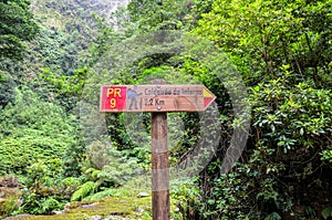 Information tourist sign giving directions and distances on a hiking trail Caldeirao de Inferno, Madeira island, Portugal. Levada