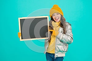 Informing kids community. Kid with blackboard. Promoting product. Child promoting event. Promotion concept. Kid cheerful photo