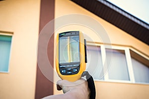 Infrared inspection of window and roof of house. Thermal imaging