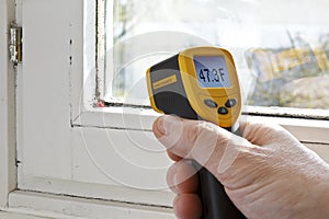 infrared laser thermometer hand window