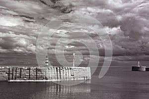 Infrared photo of iconic Seaham harbour and lighthouse with clouds