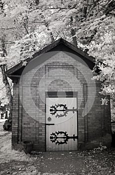 Infrared Photo of a Small Brick Building at a Cemetery