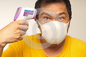 Infrared temp gun medical mask chinese man