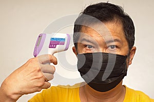 Infrared temp gun medical mask chinese man