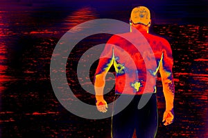 Infrared thermal vision image of muscular man back staying in front of water surface with moon glade. Calmness and strength of