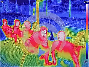 Infrared thermovision image showing when People sit at the table