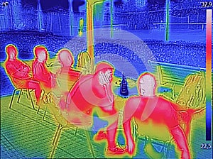 Infrared thermovision image showing when People sit at the table photo