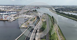Infrastructure in the port of Rotterdam. A sluice, lock system,road, and train rails, waterway, bridge and tunnel.
