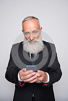 Infuriated senior man looking at smartphone