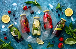 Infused water in bottles, flat lay