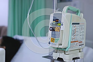 Infusion pump intravenous IV drip in the hospital with copy space background.