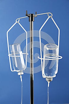 Infusion set on blue background. Intravenous therapy