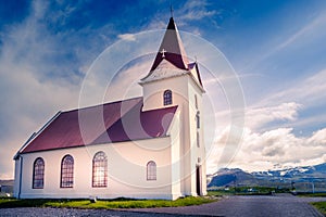 Ingjaldsholskirkja local lutheran church in sunset lights, with