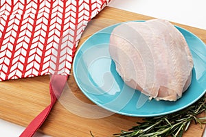 Ingredient for a healthy broth. Raw chicken breast on a plate