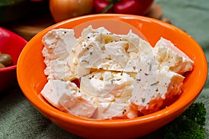 Ingredient for traditional Greek salad, fresh salted feta cheese with herbs