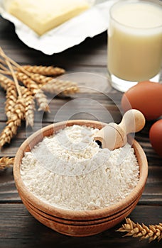 Ingredients for baking or cooking, egg flour, rolling pin butter, milk on a grey wooden background Cookie pie or cake recipe
