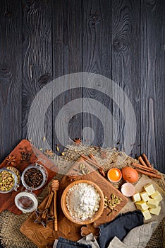Ingredients for baking ginger cookies on a rustic wooden background
