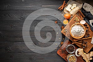 Ingredients for baking ginger cookies on a rustic wooden background