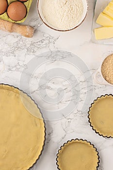 Ingredients and baking utensils for cooking tart, cookies, pastry. Flat lay with eggs, flour, butter, brown sugar.