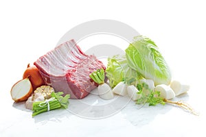 Ingredients for beef soup isolated such as beef, peppers, barbecue, coriander, onion on white marble floor and white background.