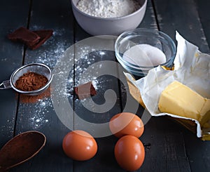 Ingredients for chocolate brownies on dark background