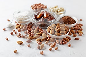 Ingredients for chocolate energy bites on white wooden table.