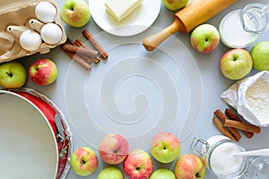 Ingredients for cooking apple pie. Fresh harvest apples, cinnamon, flour, sugar, butter, eggs, milk and baking mold