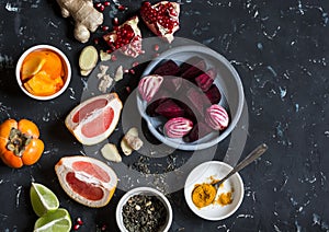 Ingredients for cooking beet and ginger detox elixir. On a dark background