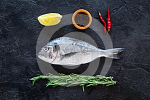 Ingredients for cooking dorado fish. Black background top view