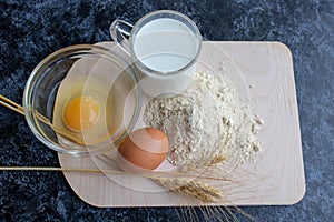 Ingredients for cooking flour products or dough. Flour, egg, milk close up. Top view. Copy space