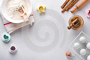 Ingredients for cooking homemade baking. Baking background with flour, eggs, kitchen tools, utensils and cookie molds on white mar