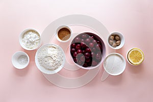 Ingredients for cooking homemade cherry lattice cake on pink background. Traditional american food. Top view