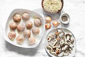 Ingredients for cooking orzo mushrooms pasta with teriyaki sauce chicken roasted meatballs on a light background, top view