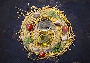 Ingredients for cooking raw homemade pasta with cherry tomatoes, parsley, pepper and butter on wooden rustic background top view c
