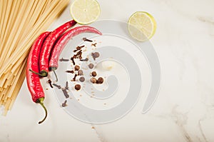 Ingredients for cooking spaghetti/Ingredients for cooking spaghetti on a white marble background. Top view. Copy space