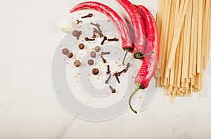 Ingredients for cooking spaghetti/Ingredients for cooking spaghetti on a white table. Top view. Copy space