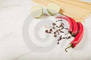 Ingredients for cooking spaghetti on a white marble background/Ingredients for cooking spaghetti on a white marble background.