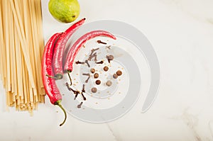 Ingredients for cooking spaghetti on a white marble background/Ingredients for cooking spaghetti on a white marble background. To