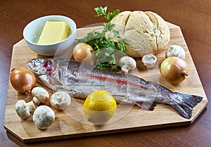 Ingredients for cooking stuffed fish mushrooms onion salad butter bread
