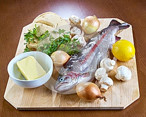 Ingredients for cooking stuffed fish mushrooms onion salad butter bread