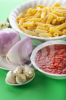 Ingredients for cooking tortiglioni bolognese pasta