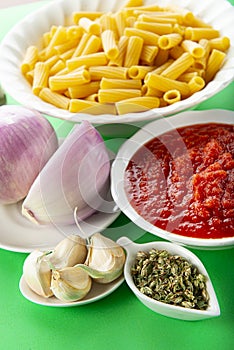 Ingredients for cooking tortiglioni bolognese pasta