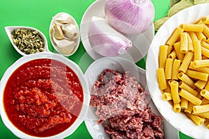 Ingredients for cooking tortiglioni bolognese pasta