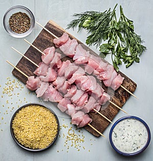 Ingredients for cooking a turkey bulgur herb seasoning garlic sauce on a cutting board on a blue wooden background top view