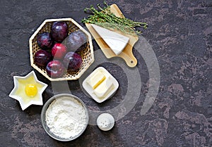 Ingredients for cooking unsweetened shortcrust pastry pie with plums, brie cheese and thyme