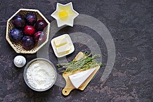 Ingredients for cooking unsweetened shortcrust pastry pie with plums, brie cheese and thyme