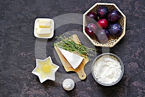 Ingredients for cooking unsweetened shortcrust pastry pie with plums, brie cheese and thyme