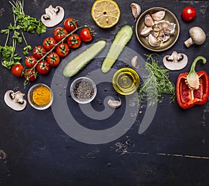 Ingredients for cooking vegetarian food tomatoes on a branch, herbs, cucumber, lemon, garlic, oil, black pepper, paprika, mushroom