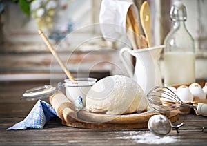 Ingredients for dough on white wooden table